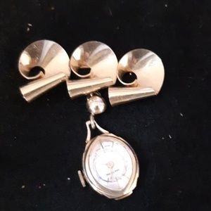 Vintage pin with watch attached.  It is wind up